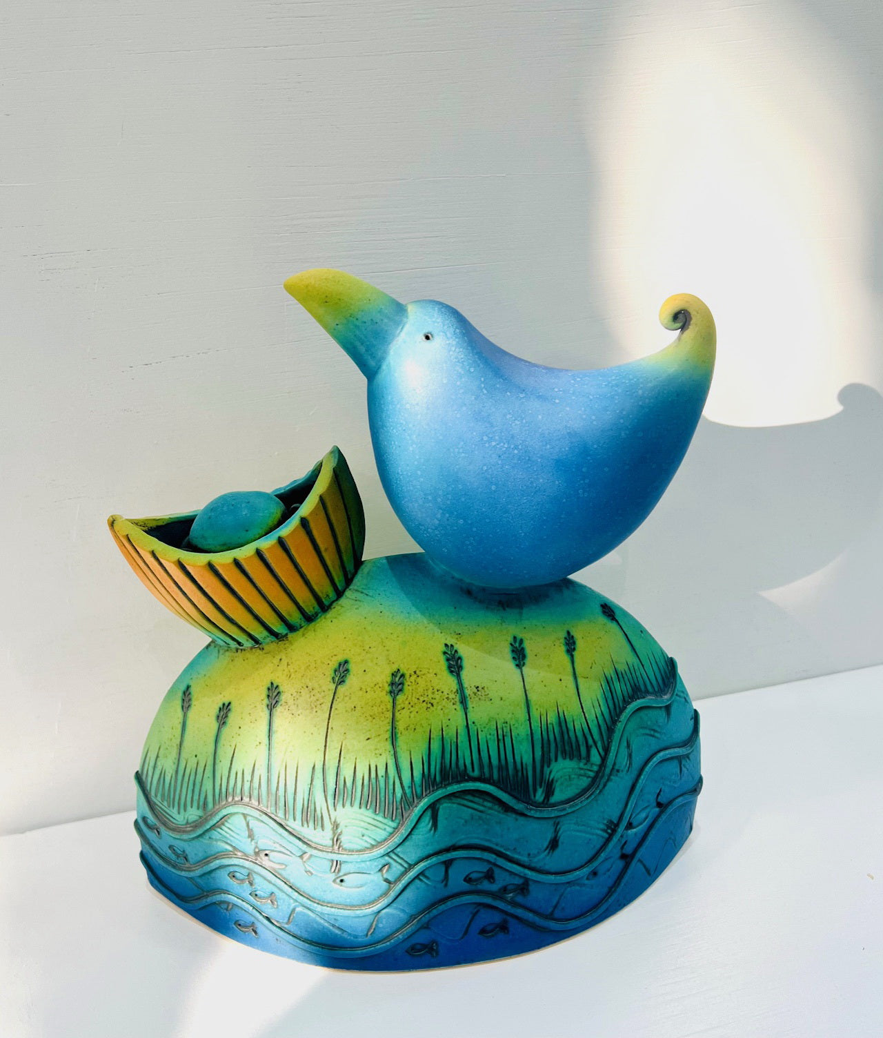 Blue Bird Nesting by the Water Edge