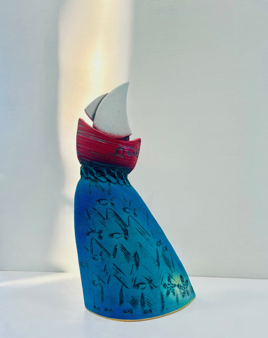 Red Yacht at the Crest of the Wave