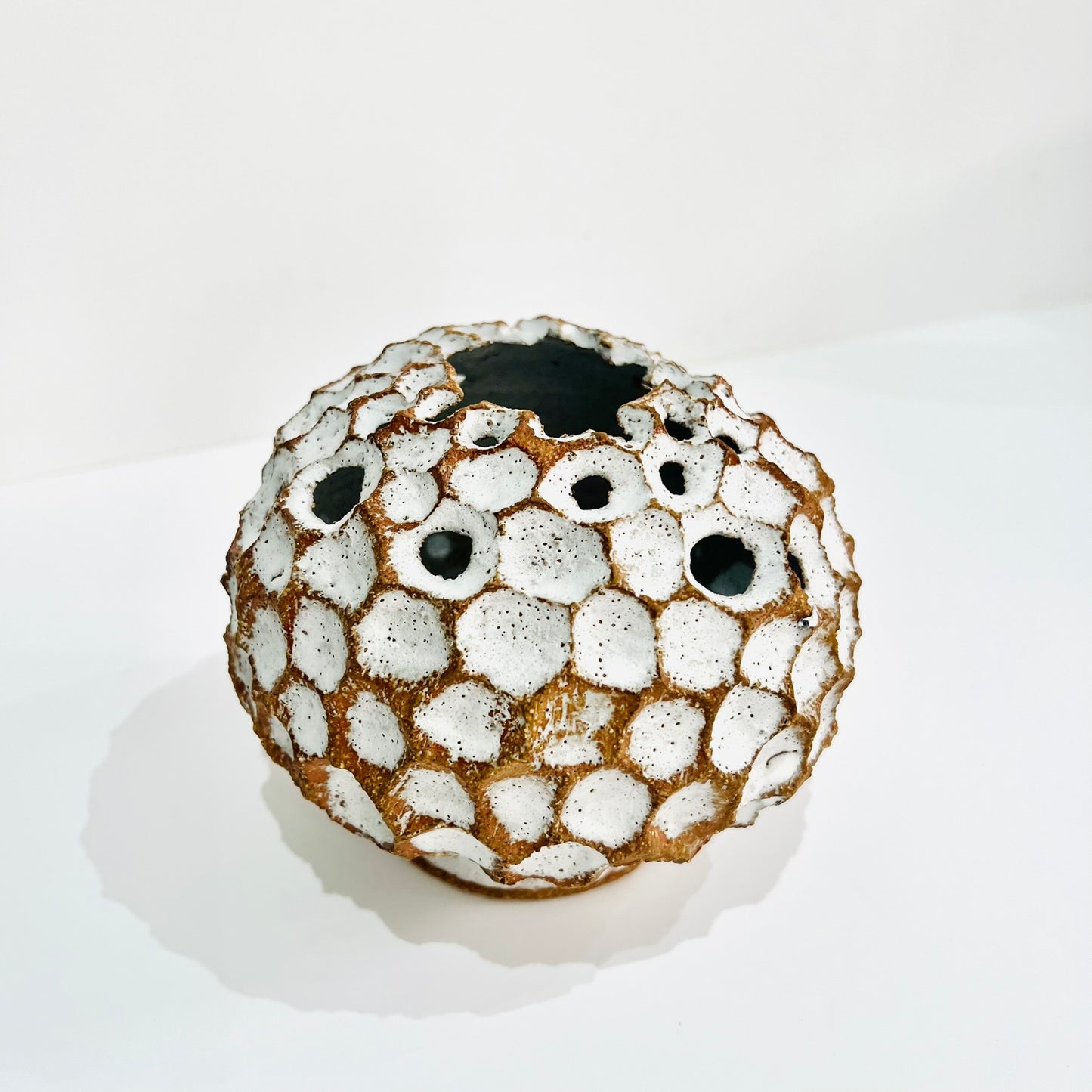 Round white carved vase