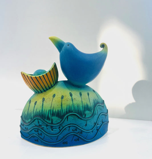 Blue Bird Nesting by the Water Edge